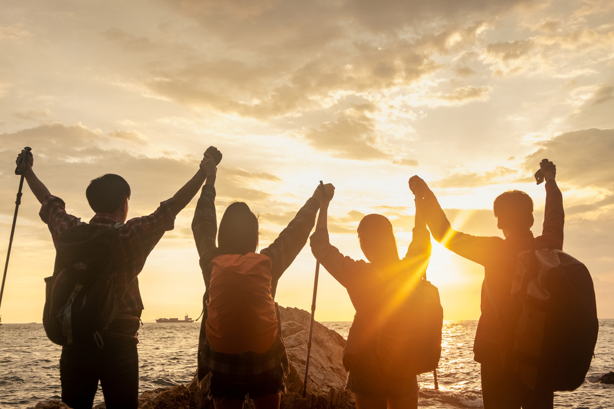 Group hikers with sunset.